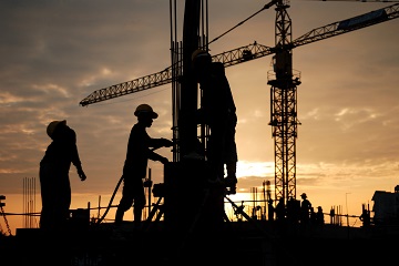 silhouette of constructionworker on constructionsite
